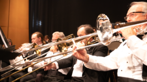 trumpet and trombone players warm up before a concert at the Pensacola Saenger Theatre